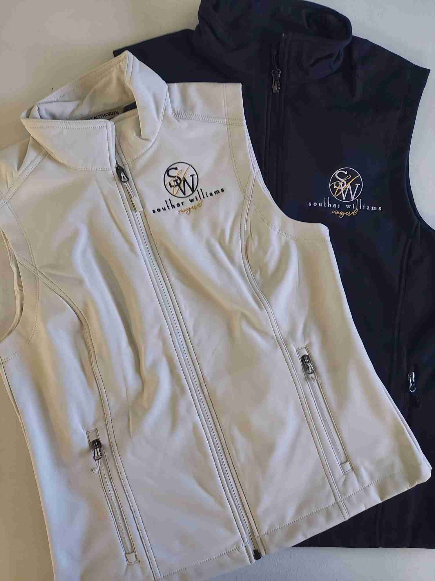 Cream and navy soft shell vests with an embroidered Souther Williams Vineyard logo for business apparel — Ultimate Swag, Mooresville NC