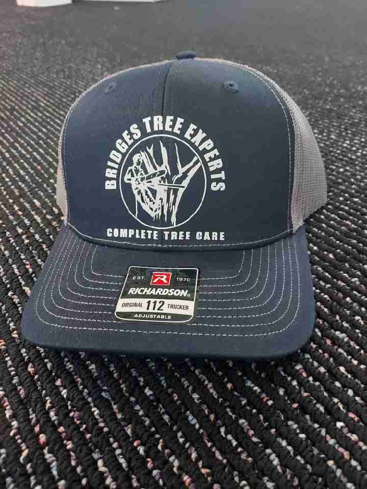 Navy and gray Richardson 112 trucker hat embroidered with a Bridges Tree Experts business logo — Ultimate Swag, Mooresville NC