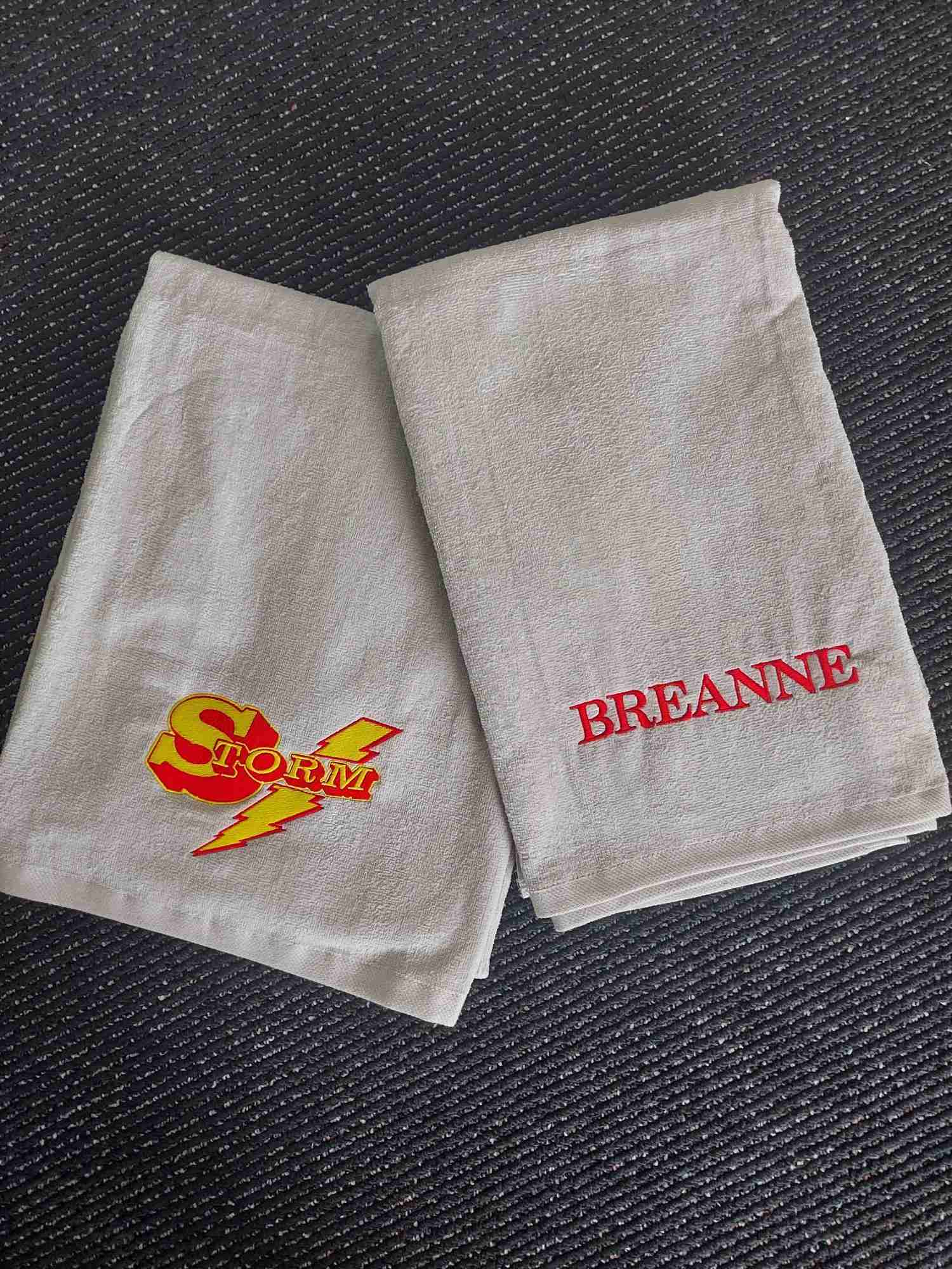 Personalized embroidered towels with a Storm team logo and custom name embroidery — Ultimate Swag, Mooresville NC